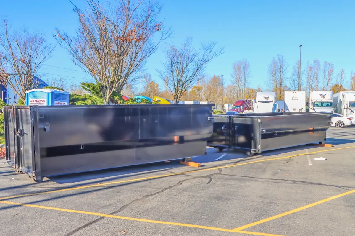 Professional dumpster rental service with roll-off container on residential driveway in Mayflower Village
